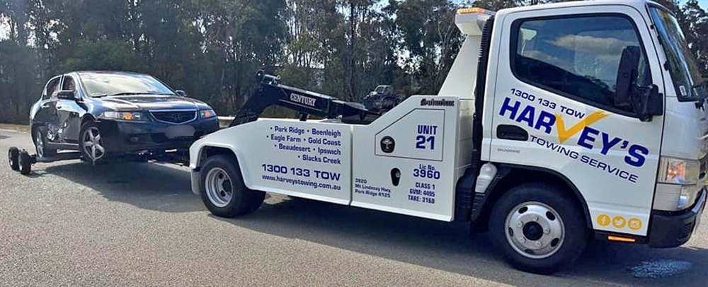 Harveys-towing-car Harvey's towing lifted vehicle on tow truck